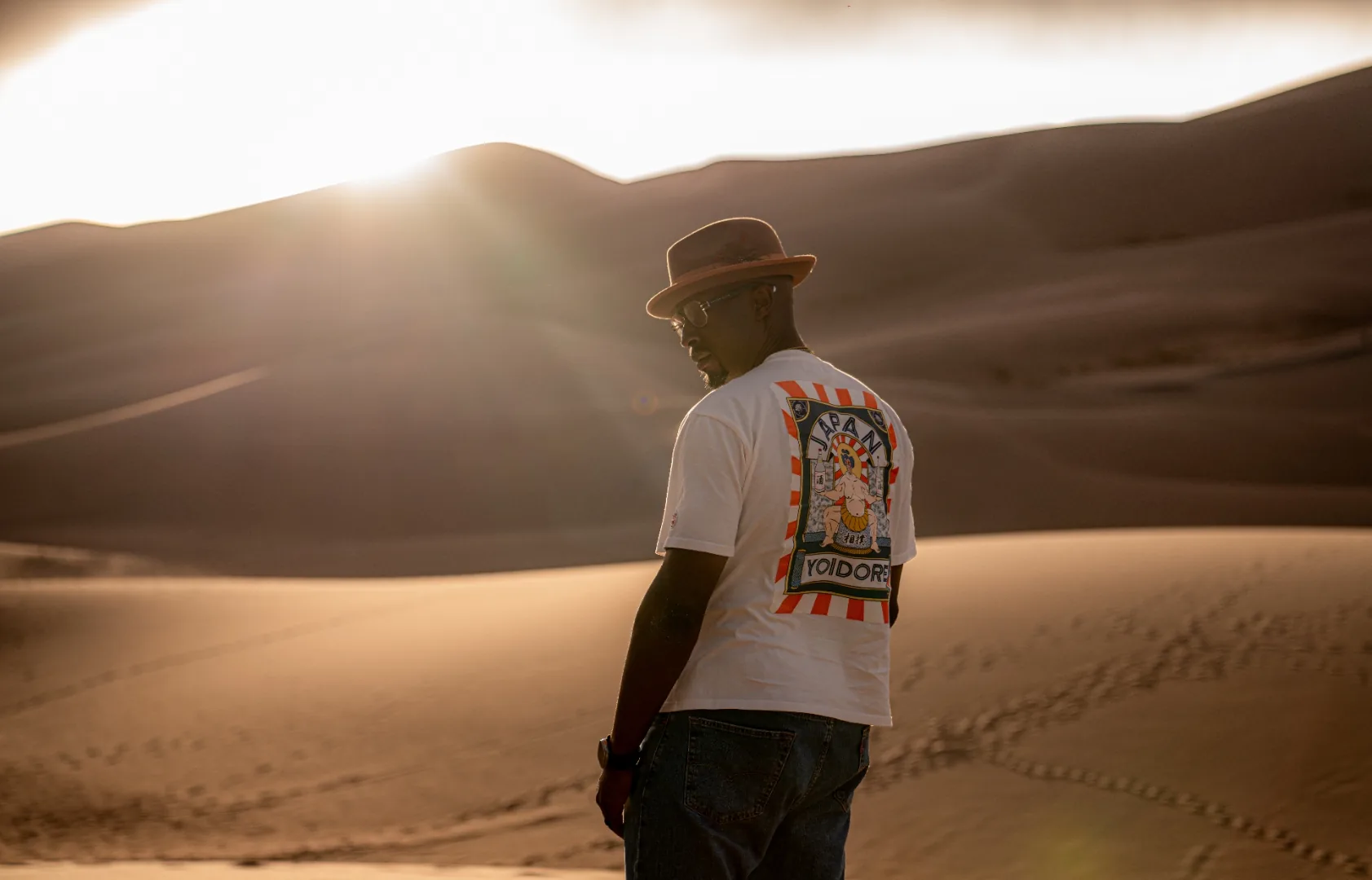 Ian Bennett looking back over his shoulder on the Great Sand Dunes at golden hour